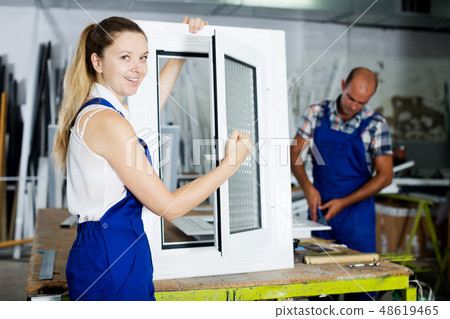 Girl in workwear with finished window Girl in workwear with finished window 48619465
