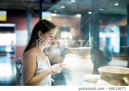 beautiful girl considers exhibits in museum beautiful girl considers exhibits in museum 48619671