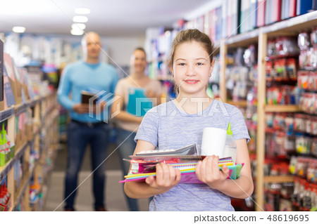 Happy girl with parents in stationery shop Happy girl with parents in stationery shop 48619695