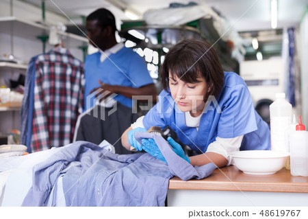 Female laundry worker during daily work Female laundry worker during daily work 48619767