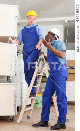 Men contractors working indoors Men contractors working indoors 48619806