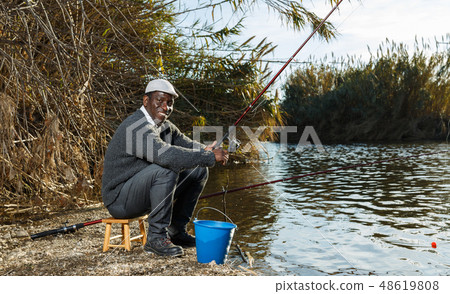 Fisherman sitting on wooden stool Fisherman sitting on wooden stool 48619808