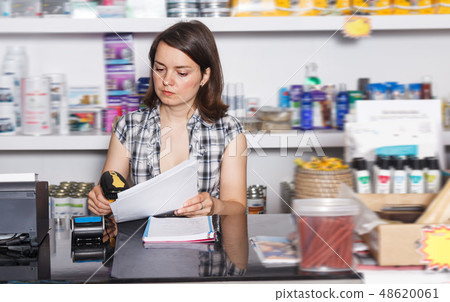 Nice woman seller working with documents Nice woman seller working with documents 48620061