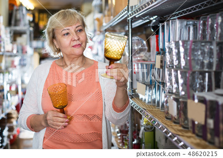 female consumer choosing wineglass female consumer choosing wineglass 48620215
