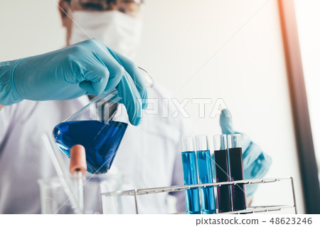 Scientific researcher or doctor pouring chemical Scientific researcher or doctor pouring chemical 48623246