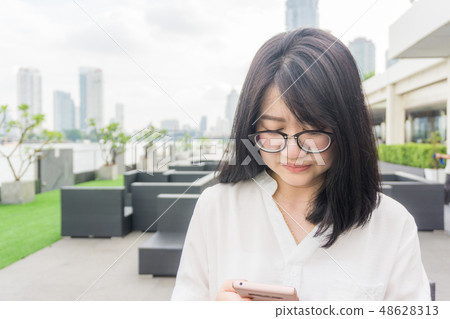 Beautiful young women working with smartphone 48628313