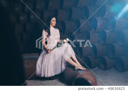 girl in a light dress barefoot with bouquet girl in a light dress barefoot with bouquet 48630825