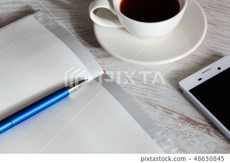 notepad and phone on the table notepad and phone on the table 48630845