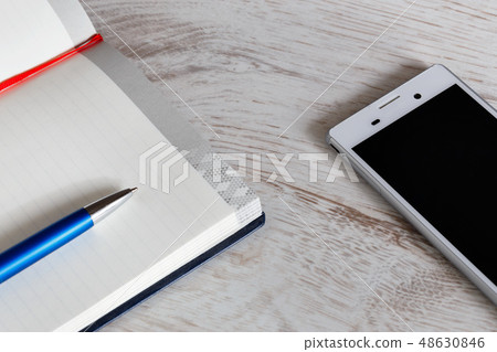 notepad and phone on the table notepad and phone on the table 48630846