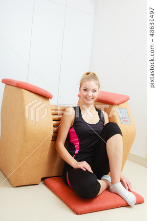 Woman relaxing after cellulite treatment on machine Woman relaxing after cellulite treatment on machine 48631497