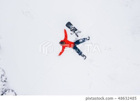 Aerial view of a man lying in the snow 48632485