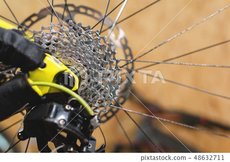 Close-up View of the bike in repair. Gear cassette close-up. Crafting service for mountain bikes Close-up View of the bike in repair. Gear cassette close-up. Crafting service for mountain bikes 48632711