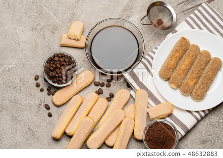 Tiramisu cake cooking - Italian Savoiardi ladyfingers Biscuits and coffee Tiramisu cake cooking - Italian Savoiardi ladyfingers Biscuits and coffee 48632883