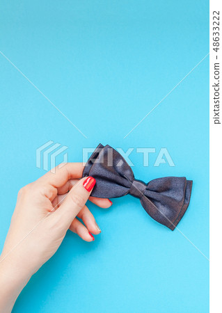 Black bow tie woman hand for men fathers concept Black bow tie woman hand for men fathers concept 48633222