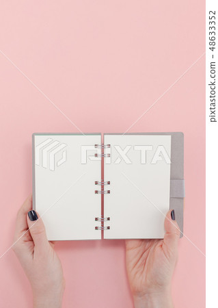 Woman hands with blank notepad mockup 48633352
