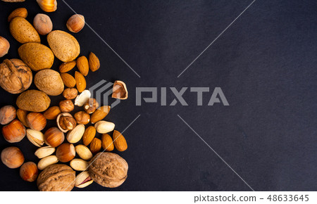 Various nuts on a pile top view Various nuts on a pile top view 48633645