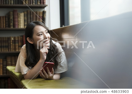 Young woman searching on her smartphone 48633903