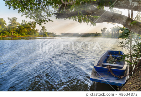 River with blue boat and sunbeam River with blue boat and sunbeam 48634872