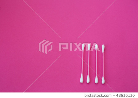 top view on four pink cotton buds with white heads 48636130