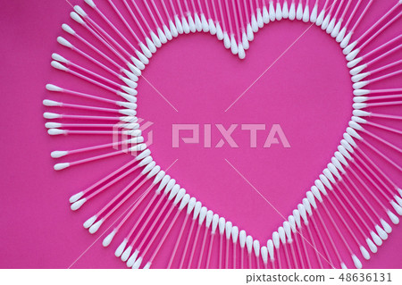 cotton buds laid out in the shape of a heart on a cotton buds laid out in the shape of a heart on a 48636131