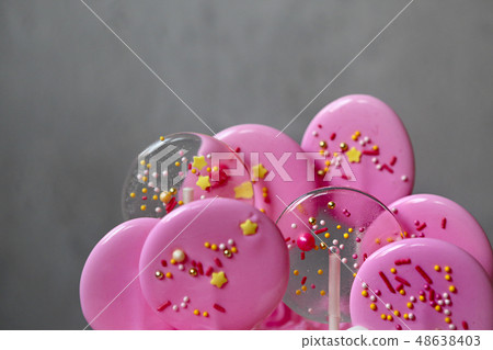 Pink caramel candies on sticks for party. Details Pink caramel candies on sticks for party. Details 48638403