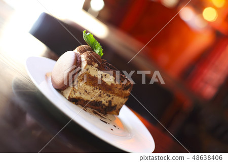 Piece of dark chocolate cake decorated with Piece of dark chocolate cake decorated with 48638406