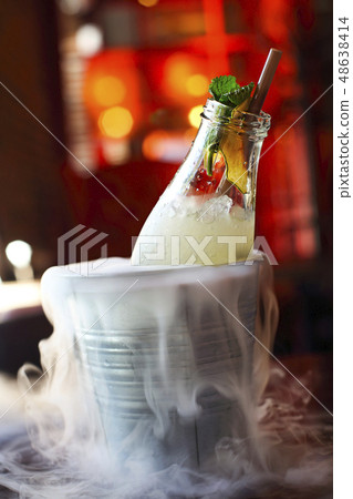 Lemonade serviced in the bottle with mint in the Lemonade serviced in the bottle with mint in the 48638414