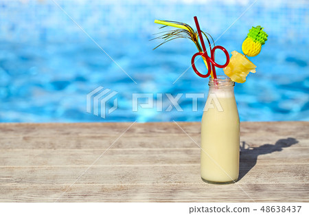 Glass of pinacolada cocktail standing on the 48638437