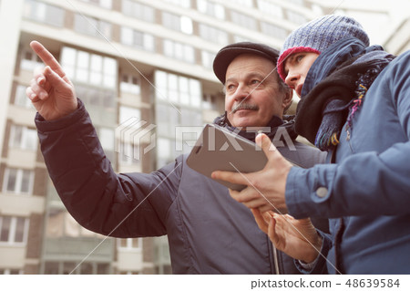 A young girl with a tablet ask for help 48639584