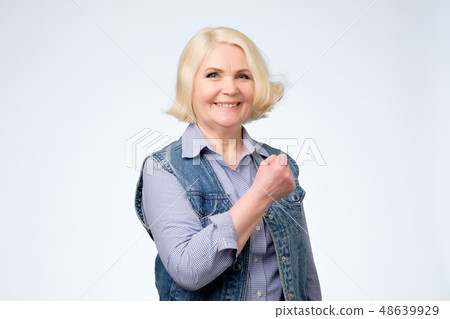 Beautiful lucky senior woman feeling excited  48639929