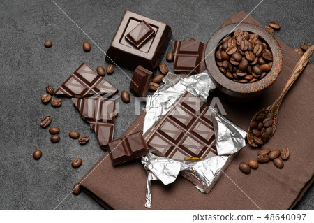 dark organic chocolate and coffee beans on concrete background dark organic chocolate and coffee beans on concrete background 48640097