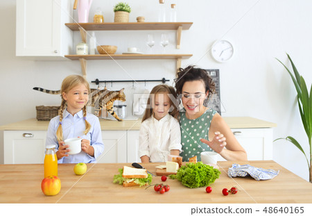 Happy young brunette mother with cute little kids 48640165