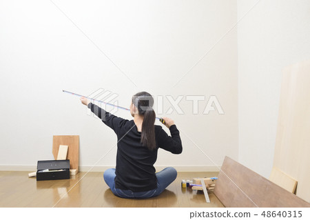 A woman taking a DIY measure 48640315