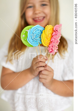 Cute little girl with candies pop 48640596