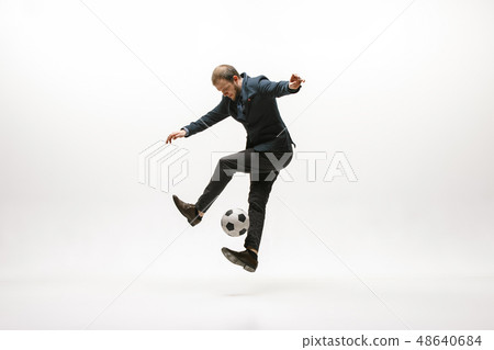 Businessman with football ball in office Businessman with football ball in office 48640684