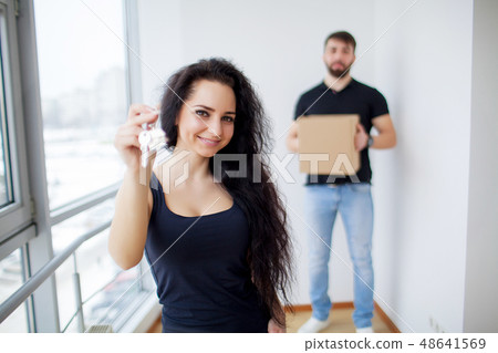 Moving day. Happy young couple carrying boxes Moving day. Happy young couple carrying boxes 48641569