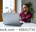 Man in glasses sitting at home office and working 48641736