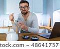 Bearded man having breakfast in the kitchen and 48641737