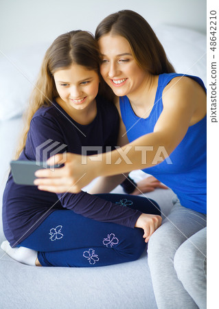 Beauty and Care. Young Woman with Cream for Face in Hands. Morni Beauty and Care. Young Woman with Cream for Face in Hands. Morni 48642210
