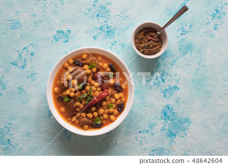 Stewed meat with bulgur and chickpeas in red sauce 48642604