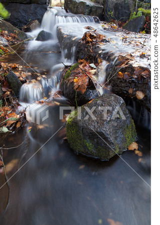 Water flowing over rocks in creek Water flowing over rocks in creek 48642625
