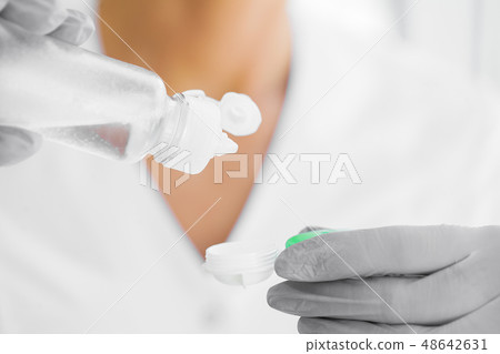 Vision And Medicine Concept. Young Girl Holds Eye Drops In Hands. Portrait of a Beautiful Woman with 48642631