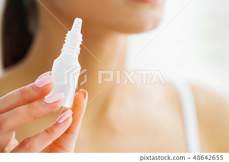 Vision And Medicine Concept. Young Girl Holds Eye Drops In Hands. Portrait of a Beautiful Woman with 48642655
