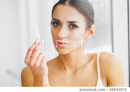 Health and Beauty. Eye Care. Beautiful Young Woman Holding Drops For Eyes. Good Vision. Happy Girl 48642672