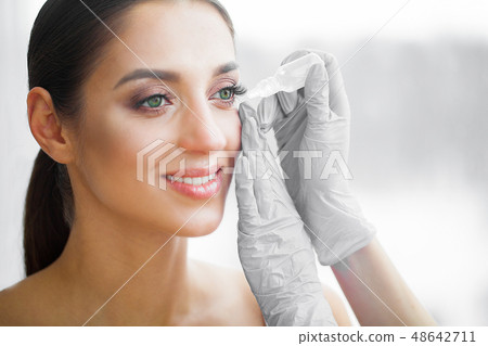 Health and Beauty. Eye Care. Beautiful Young Woman Holding Drops For Eyes. Good Vision. Happy Girl 48642711