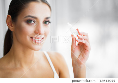 Health and Beauty. Eye Care. Beautiful Young Woman Holding Drops For Eyes. Good Vision. Happy Girl 48643055