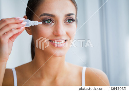 Health and Beauty. Eye Care. Beautiful Young Woman Holding Drops For Eyes. Good Vision. Happy Girl 48643085