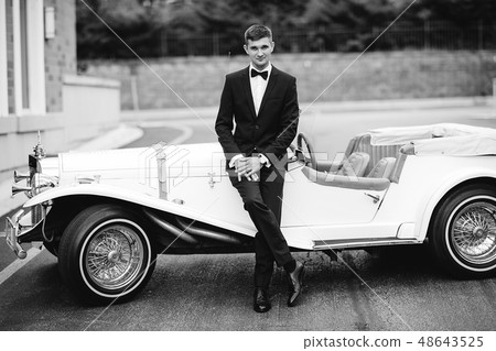 Groom near car Groom near car 48643525