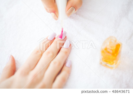 Beauty and Care. Manicure Master Applying Nail Polish in Beauty Salon. Beautiful Women's Hands with Beauty and Care. Manicure Master Applying Nail Polish in Beauty Salon. Beautiful Women's Hands with 48643671
