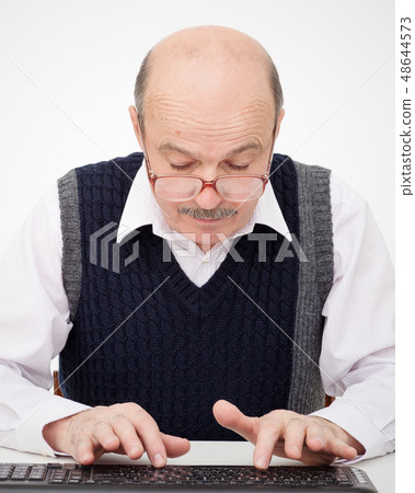 Elderly man learn to type on a keyboard Elderly man learn to type on a keyboard 48644573